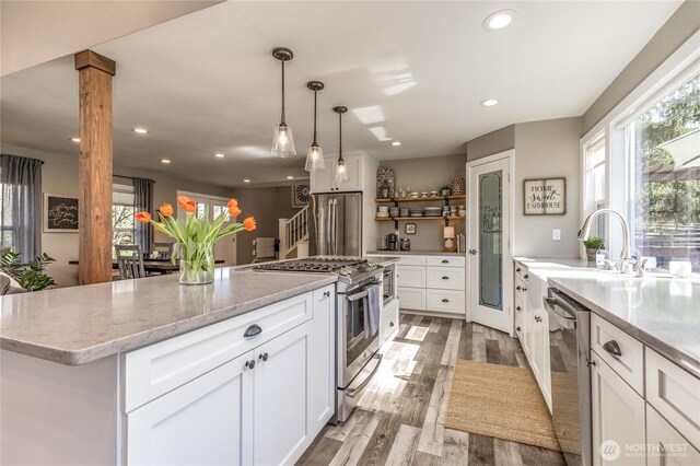 16005 SE Lake Holm Rd, Auburn, WA 98092 - kitchen featuring white cabinetry, recessed lighting, stainless steel appliances, a kitchen island, and light wood-style floors