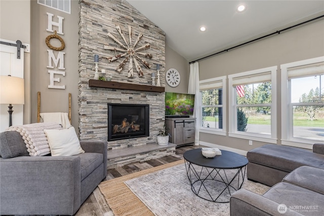 16005 SE Lake Holm Rd, Auburn, WA 98092 - living area with a wealth of natural light, visible vents, a barn door, and wood finished floors