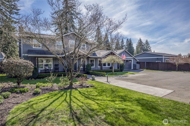16005 SE Lake Holm Rd, Auburn, WA 98092 - view of front facade featuring aphalt driveway, fence, a garage, a front lawn, and a residential view