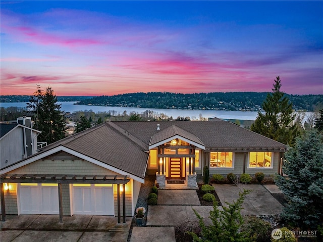 11230 SE 76th Pl, Newcastle, WA 98056 - view of front facade with a water view, a garage, concrete driveway, and roof with shingles