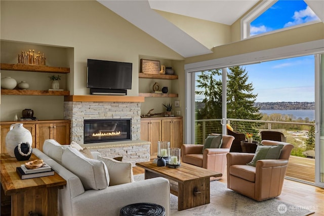 11230 SE 76th Pl, Newcastle, WA 98056 - living room featuring a fireplace, high vaulted ceiling, light wood-style floors, and a healthy amount of sunlight