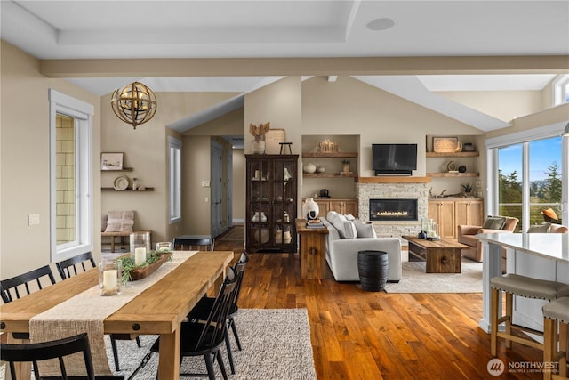 11230 SE 76th Pl, Newcastle, WA 98056 - dining space with vaulted ceiling, wood finished floors, an inviting chandelier, and a stone fireplace