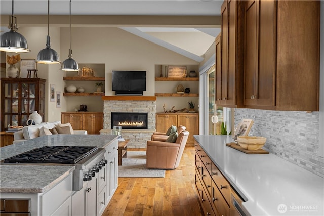 11230 SE 76th Pl, Newcastle, WA 98056 - kitchen with light countertops, stainless steel gas cooktop, vaulted ceiling, light wood-style flooring, and white cabinets