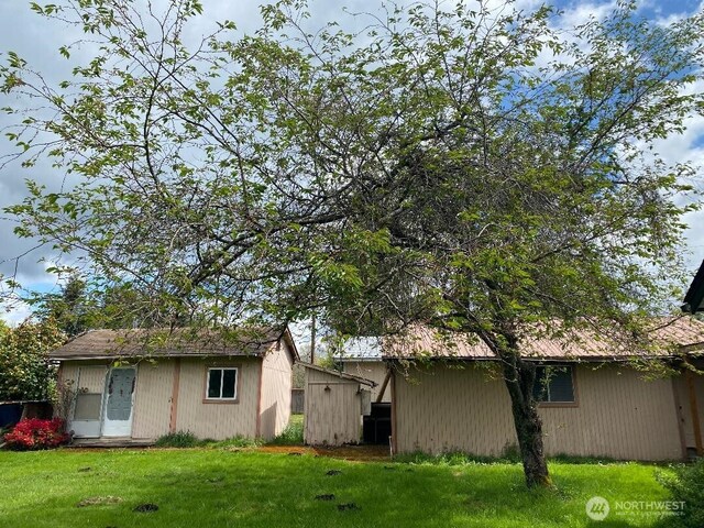 143 Huntting Rd, Silver Creek, WA 98585 - view of home's exterior with an outdoor structure, a shed, and a lawn