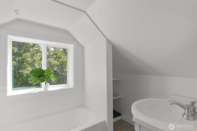 275 State Route 409, Cathlamet, WA 98612 - full bathroom featuring a tub to relax in, lofted ceiling, and a sink