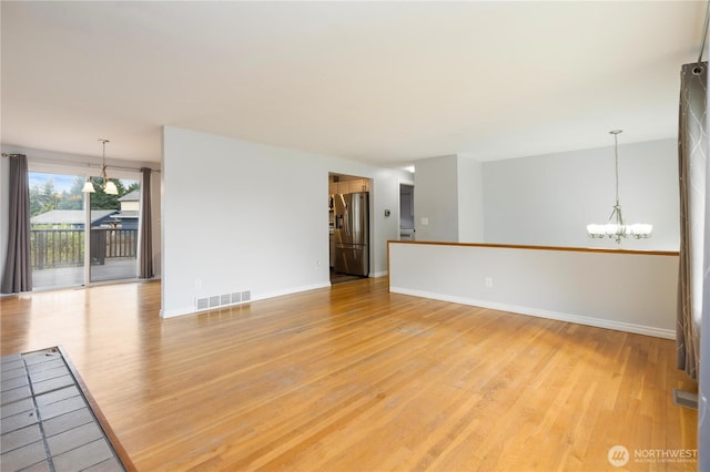13729 8th Ave S, Burien, WA 98168 - spare room with baseboards, an inviting chandelier, visible vents, and light wood-style flooring