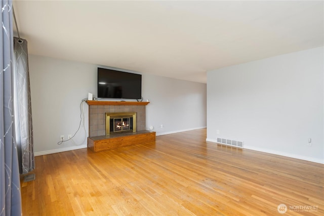 13729 8th Ave S, Burien, WA 98168 - unfurnished living room with a fireplace, light wood-style floors, visible vents, and baseboards