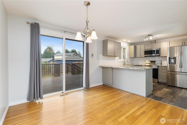 13729 8th Ave S, Burien, WA 98168 - kitchen with decorative backsplash, wood finished floors, appliances with stainless steel finishes, and gray cabinets