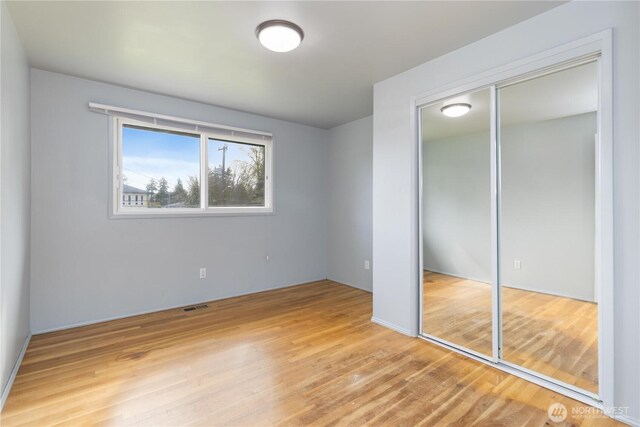 13729 8th Ave S, Burien, WA 98168 - unfurnished bedroom featuring wood finished floors, visible vents, and a closet