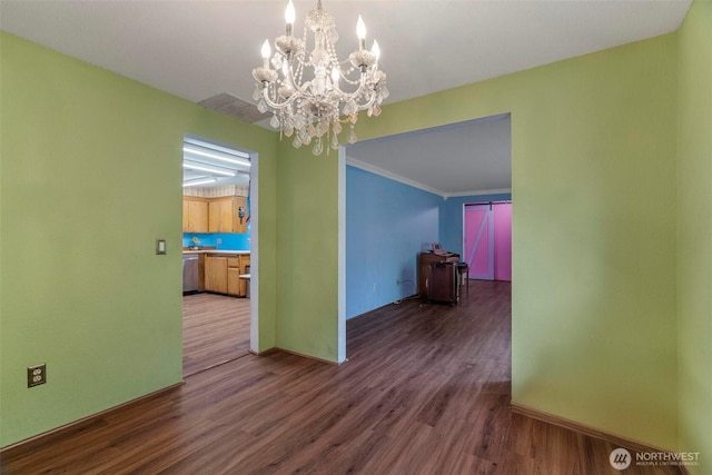 4901 Delta Ln SE, Tumwater, WA 98501 - unfurnished dining area with wood finished floors, a chandelier, baseboards, and ornamental molding