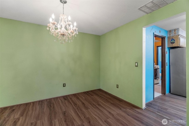 4901 Delta Ln SE, Tumwater, WA 98501 - spare room featuring wood finished floors and a chandelier