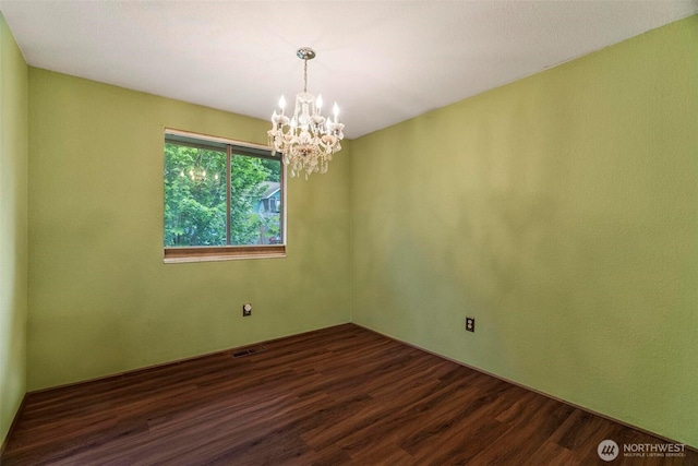 4901 Delta Ln SE, Tumwater, WA 98501 - unfurnished room featuring a chandelier and dark wood-type flooring