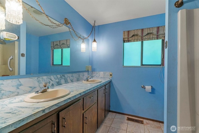 4901 Delta Ln SE, Tumwater, WA 98501 - bathroom with healthy amount of natural light, double vanity, and baseboards