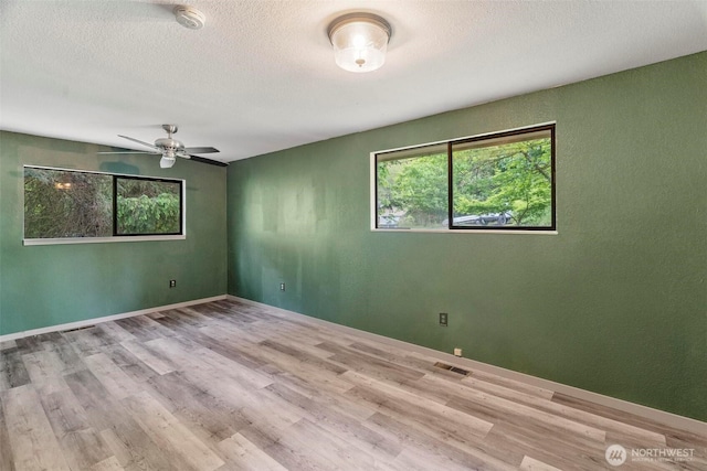 4901 Delta Ln SE, Tumwater, WA 98501 - empty room featuring wood finished floors, a ceiling fan, a smoke detector, a textured ceiling, and baseboards