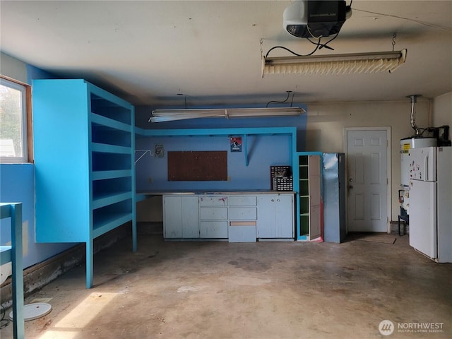 4901 Delta Ln SE, Tumwater, WA 98501 - garage featuring a garage door opener and freestanding refrigerator