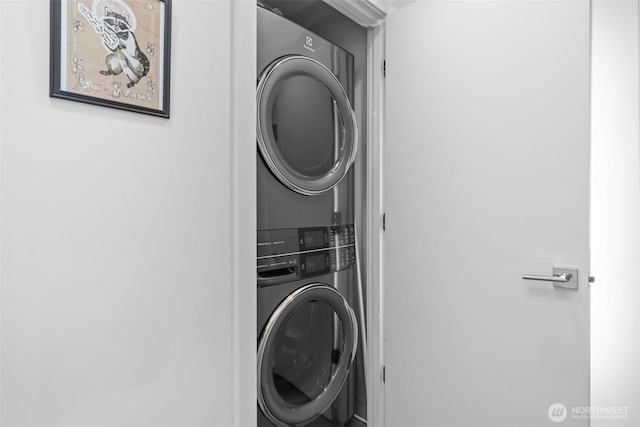 washroom with stacked washer / drying machine and laundry area