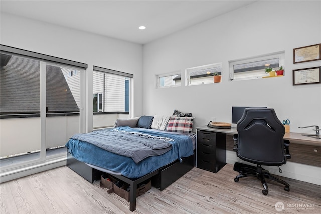 bedroom with recessed lighting and wood finished floors