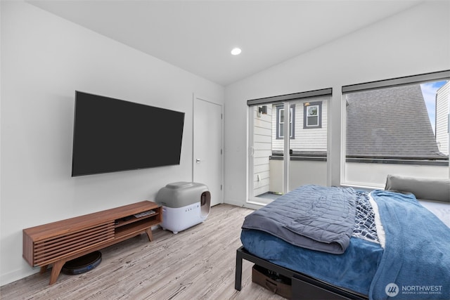 bedroom featuring baseboards, vaulted ceiling, recessed lighting, and wood finished floors