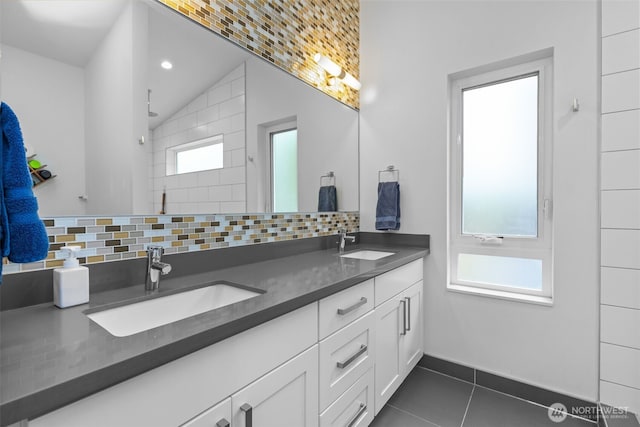 full bath featuring a sink, tile patterned flooring, and decorative backsplash