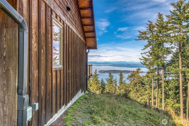 view of side of home with a water view