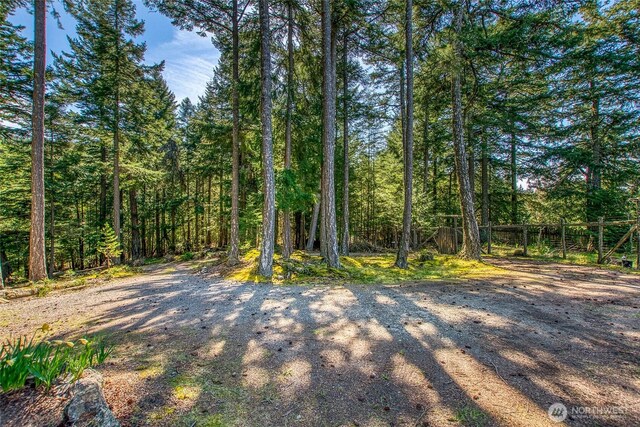 view of landscape featuring a forest view