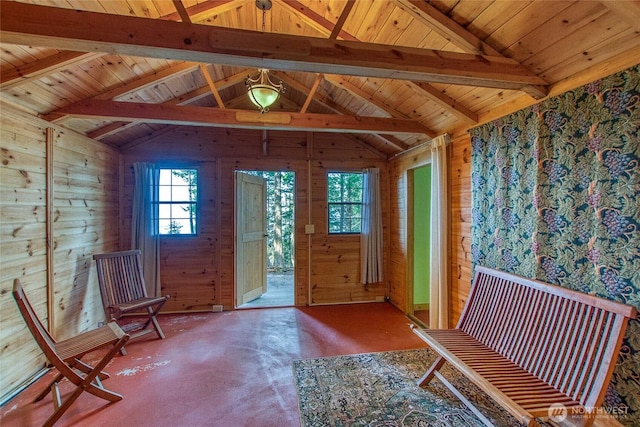 unfurnished room with concrete flooring, wooden walls, and lofted ceiling