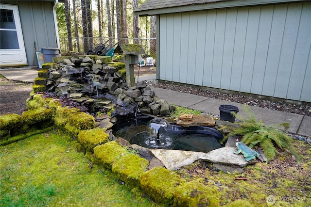 view of yard with a garden pond