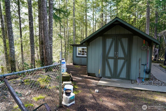 view of shed with a forest view
