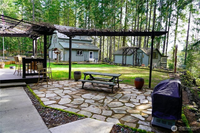 exterior space featuring a pergola, a grill, outdoor dining area, and an outbuilding