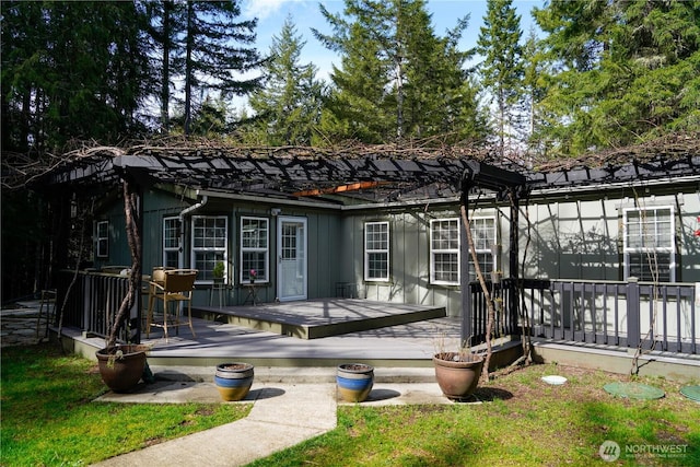 back of house featuring a wooden deck and board and batten siding