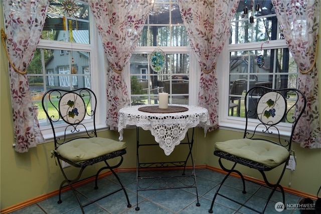dining room featuring baseboards and tile patterned flooring