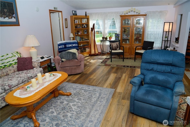living area with visible vents and wood finished floors