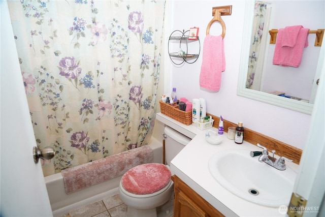 bathroom featuring tile patterned floors, toilet, vanity, and shower / bath combo