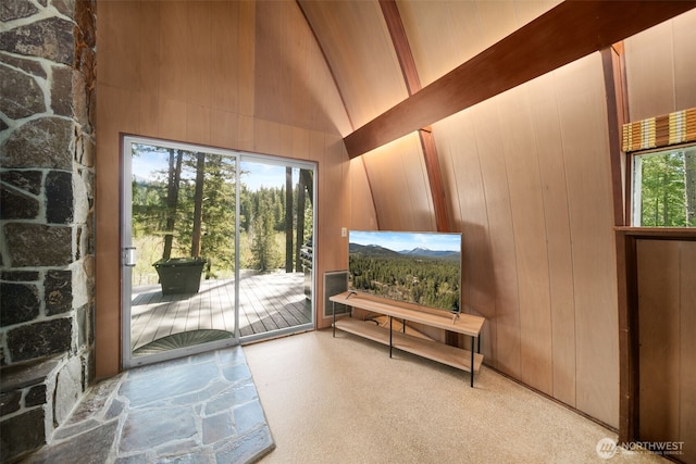 doorway featuring high vaulted ceiling and beam ceiling