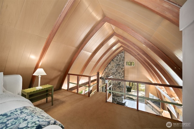 bedroom with carpet flooring and lofted ceiling