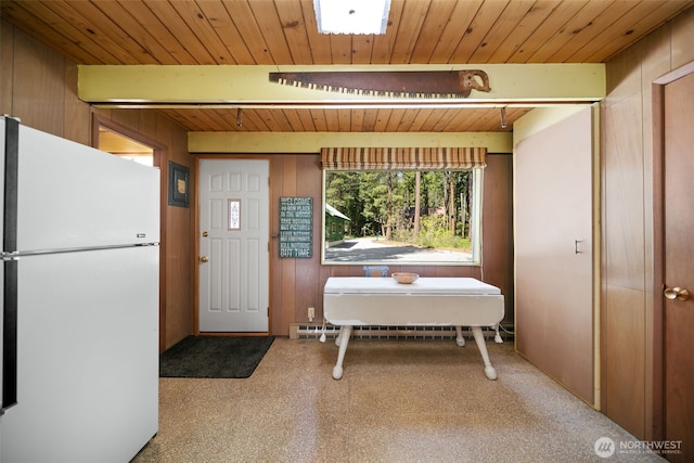 interior space with wood walls, wooden ceiling, and beam ceiling
