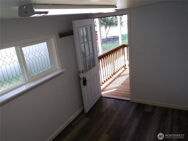 entryway featuring baseboards and dark wood finished floors