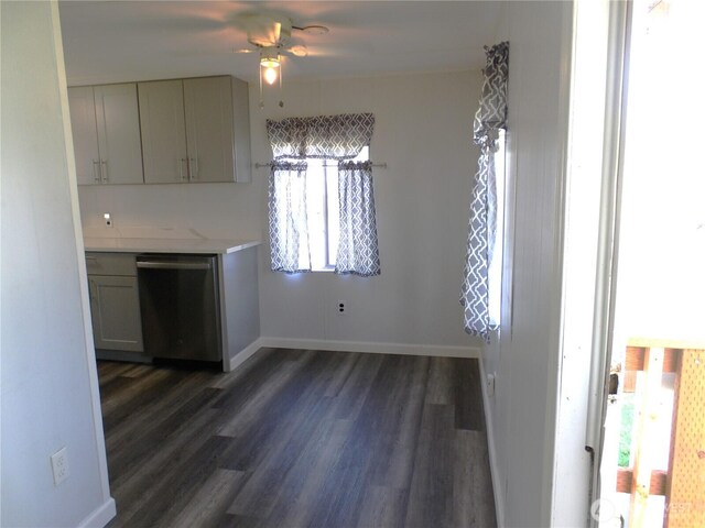 interior space featuring baseboards, ceiling fan, and dark wood finished floors