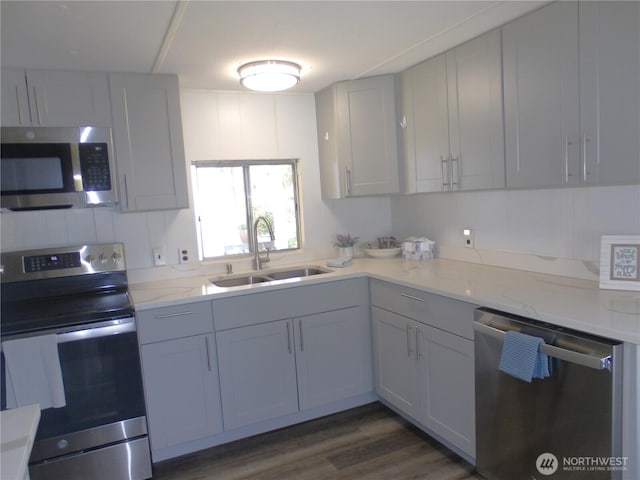 1308 263rd Pl, Ocean Park, WA 98640 - kitchen featuring appliances with stainless steel finishes, dark wood-type flooring, and light stone countertops