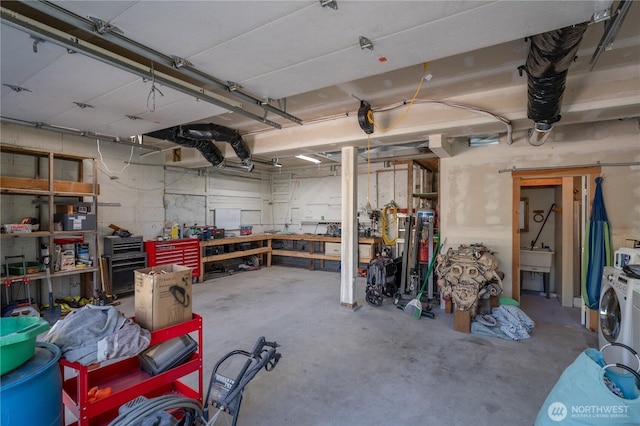 garage featuring separate washer and dryer and a workshop area