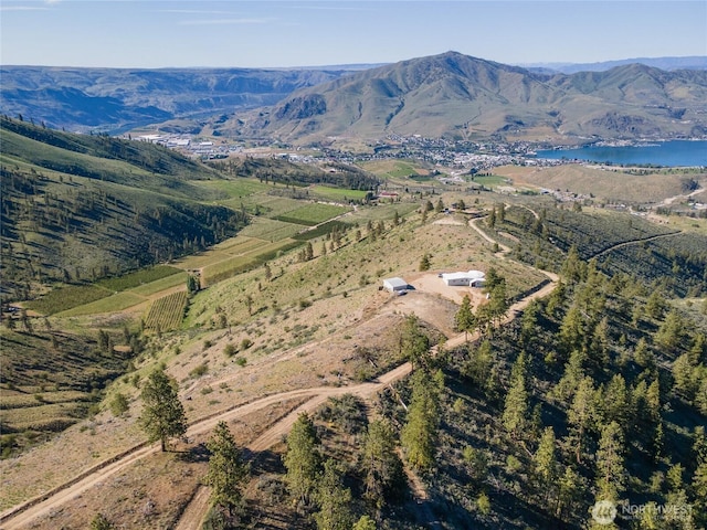 aerial view featuring a water and mountain view