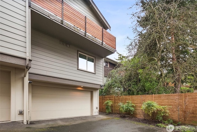 3924 S Brandon St Unit A, Seattle, WA 98118 - view of home's exterior with fence, driveway, and a garage