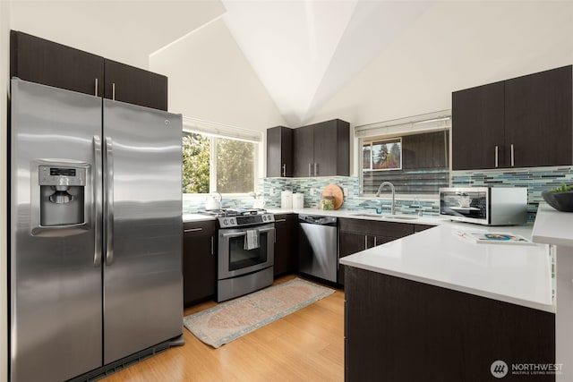 3924 S Brandon St Unit A, Seattle, WA 98118 - kitchen featuring stainless steel appliances, light countertops, a sink, and tasteful backsplash