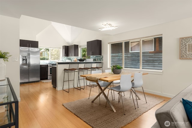 3924 S Brandon St Unit A, Seattle, WA 98118 - dining room featuring light wood-style floors and lofted ceiling