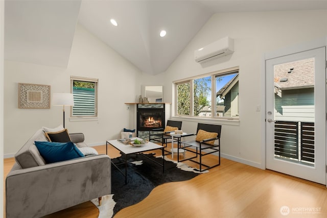 3924 S Brandon St Unit A, Seattle, WA 98118 - office area with a glass covered fireplace, baseboards, wood finished floors, and a wall unit AC