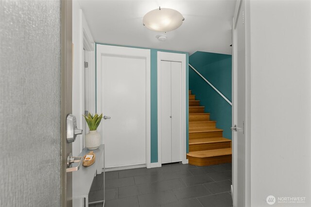 3924 S Brandon St Unit A, Seattle, WA 98118 - entrance foyer with dark tile patterned floors and stairs