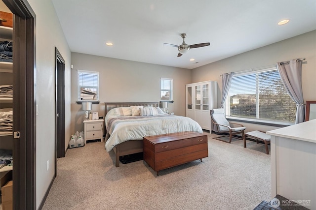 bedroom featuring recessed lighting, multiple windows, and light carpet