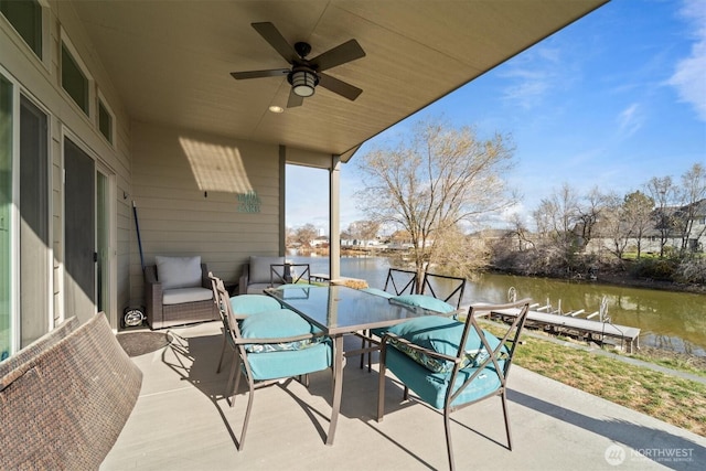view of patio / terrace with a water view, ceiling fan, and outdoor dining space