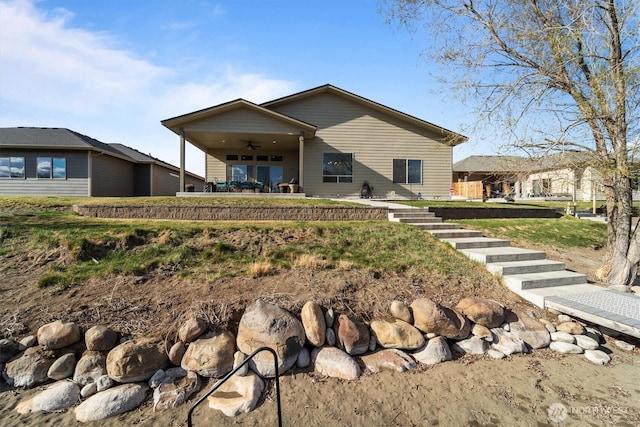 back of property featuring a ceiling fan