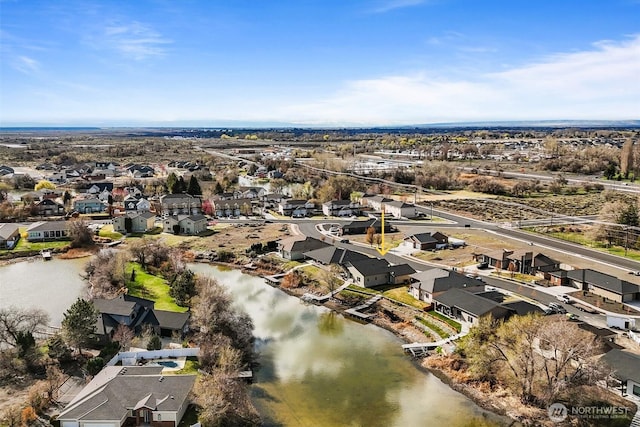 birds eye view of property featuring a water view and a residential view